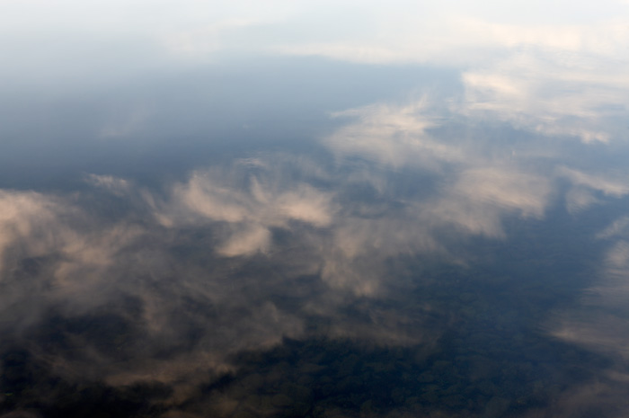 Reflections of the clouds on the water at the lake.